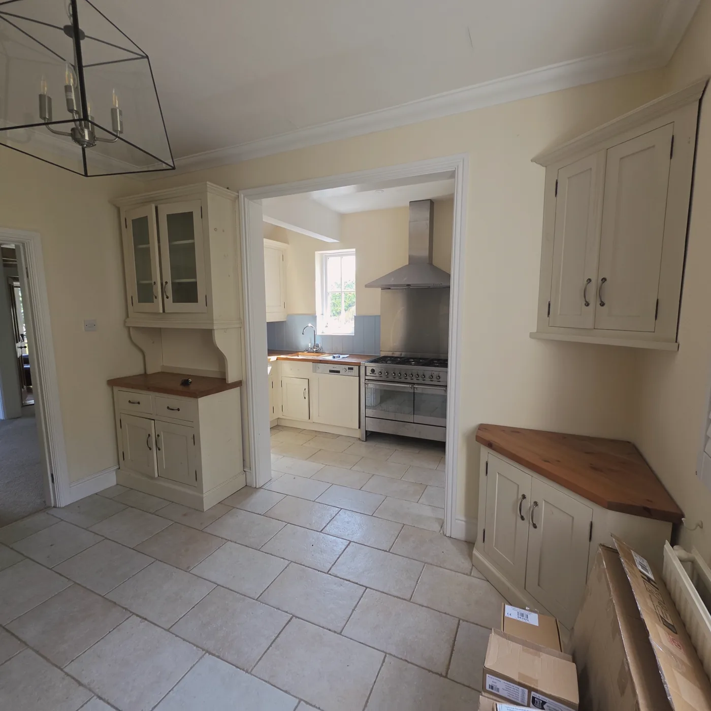 The original cream traditional kitchen with a tiled floor.
