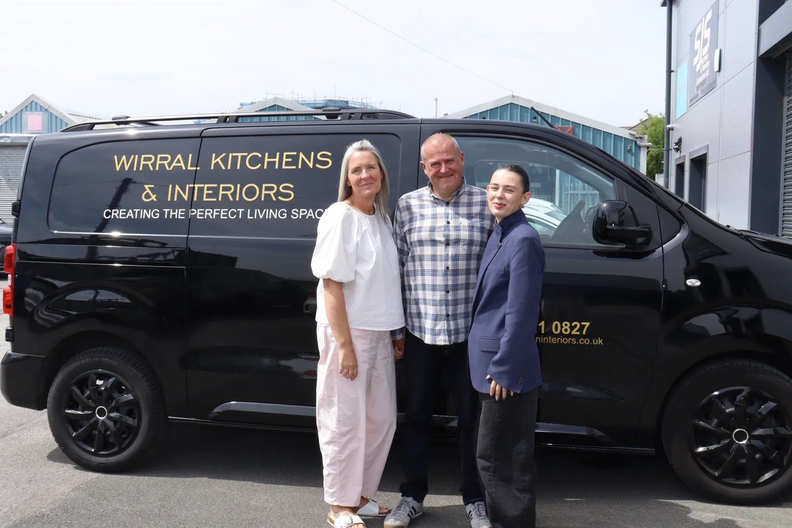 The Wirral Kitchens & Interiors team standing beside the branded company van outside the Hoylake showroom.